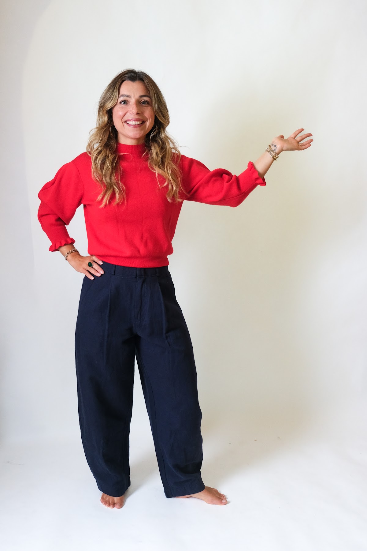 Simone in a red sweater, mid-gesture