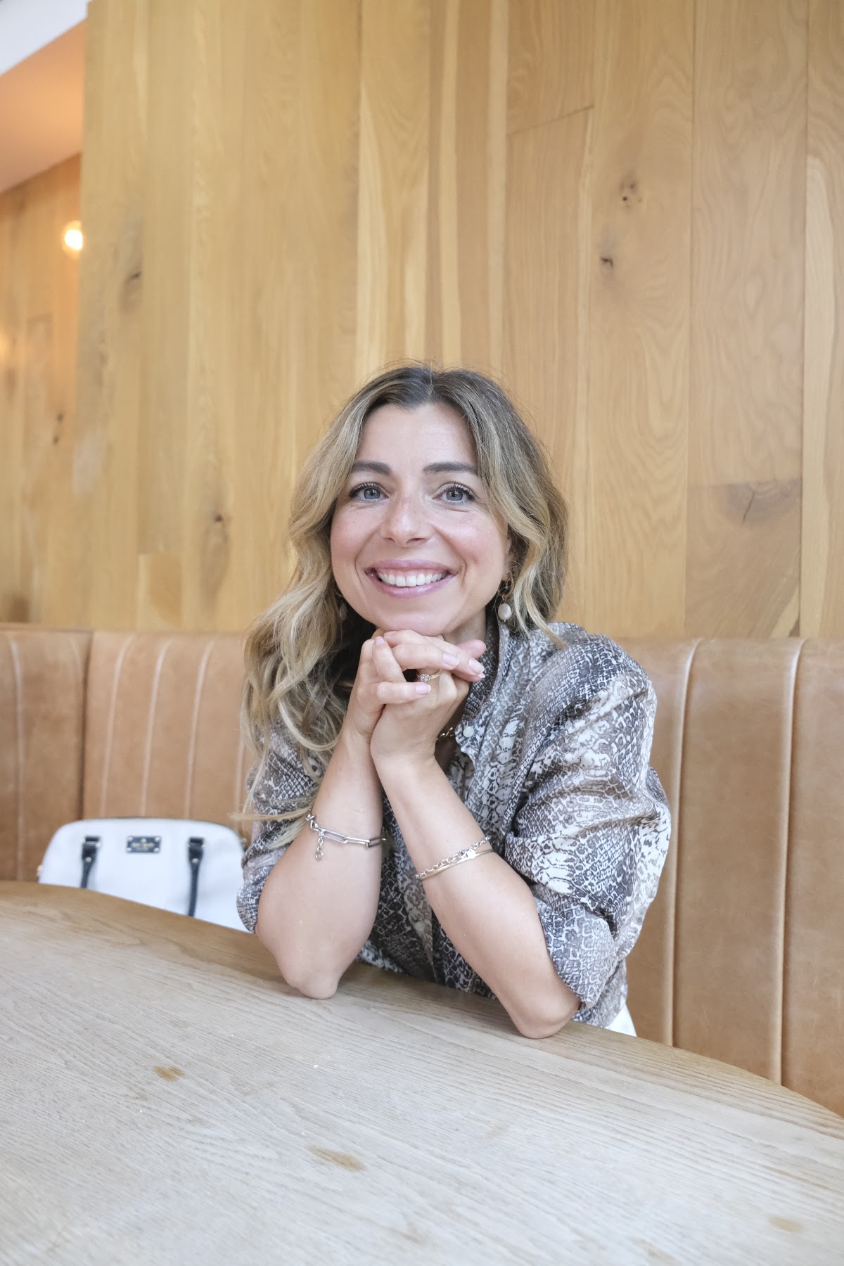 Simone smiling across a café table